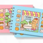 Livro de colorir Bobbie Goods nas versões azul e rosa com capa ilustrada